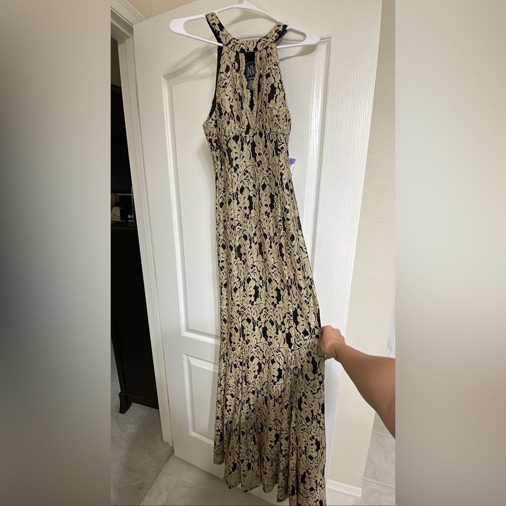 Very elegant formal dress. Black and gold mermaid cut fits the body like a glove